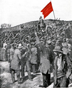 Den första socialdemokrtiska förstamajdemonstrationen på Ladugårdslandsgärdet 1890. August Palm i talarstolen kräver allmän rösträtt och åttatimmarsdag. Marschen mot makten har inletts.